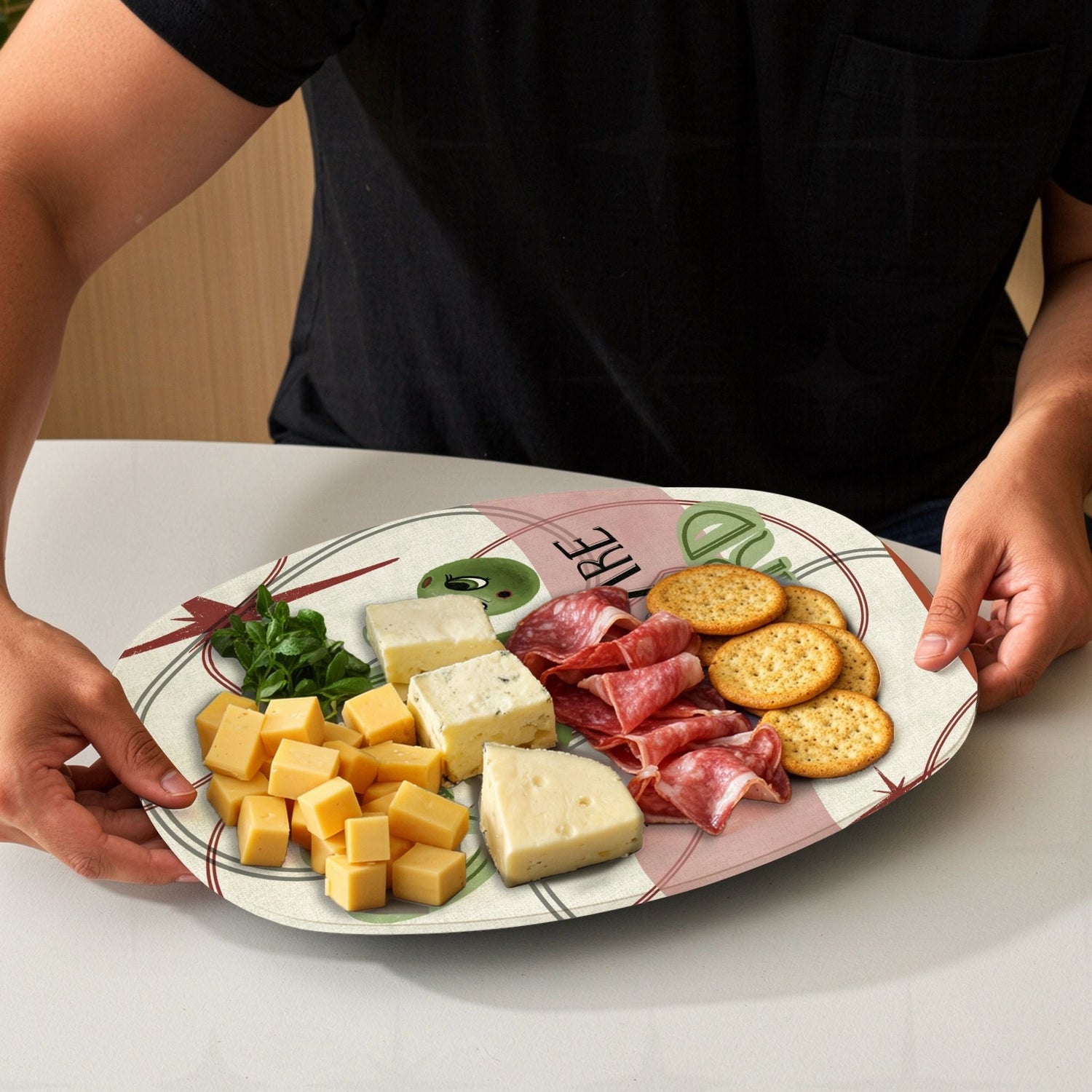 Funny retro serving platter loaded with charcuterie board spread including cheese, meats and crackers, mid-century olive pun illustration visible at edges
