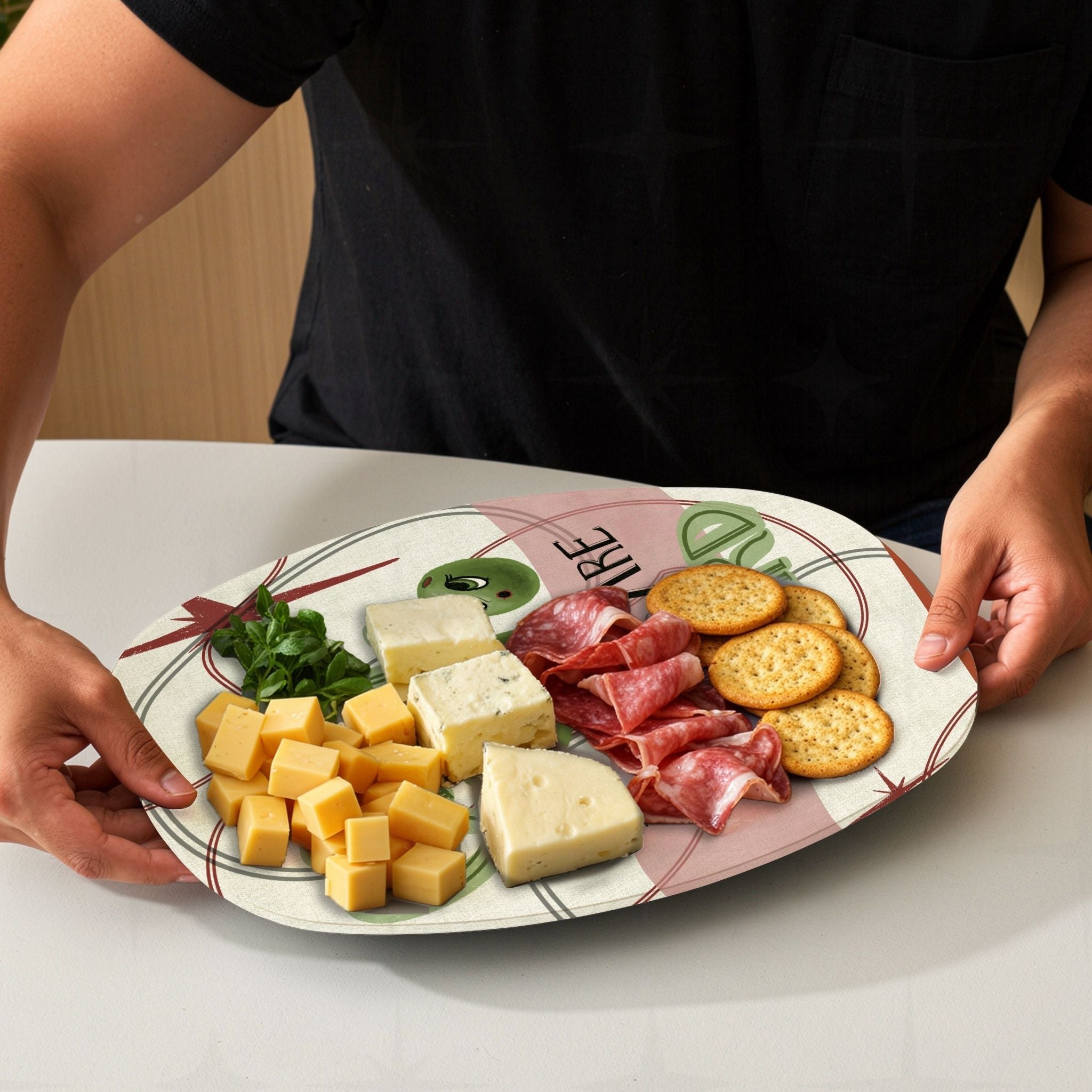 Funny retro serving platter loaded with charcuterie board spread including cheese, meats and crackers, mid-century olive pun illustration visible at edges