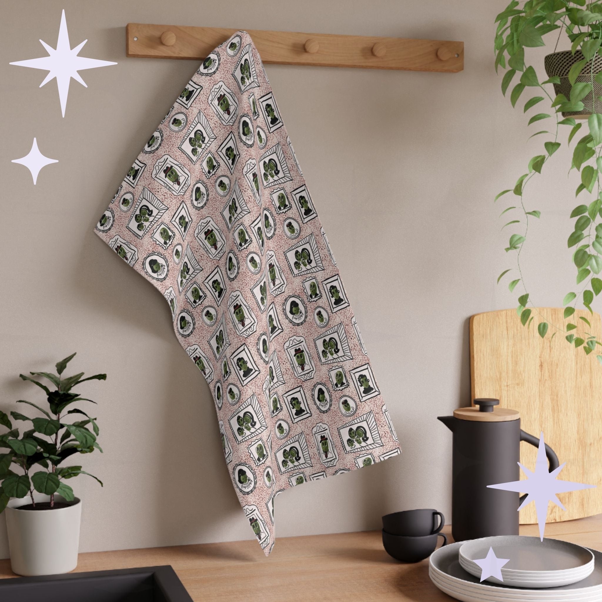 Dusty rose retro olive tea towel with mid-century portrait repeat pattern hanging from wooden wall peg rack in styled kitchen