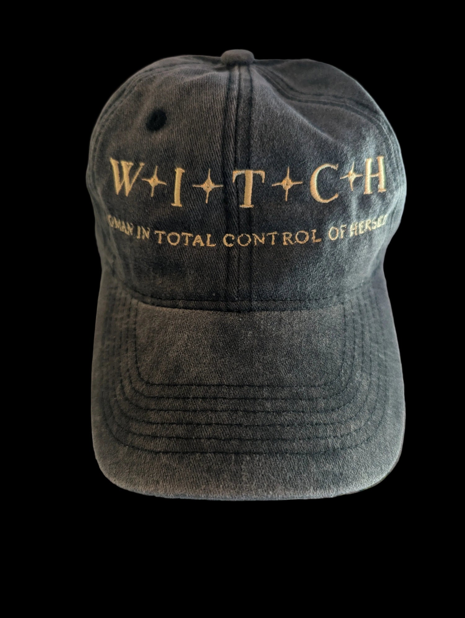 Black vintage washed cap with gold text on a black background