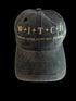 Black vintage washed cap with gold text on a black background