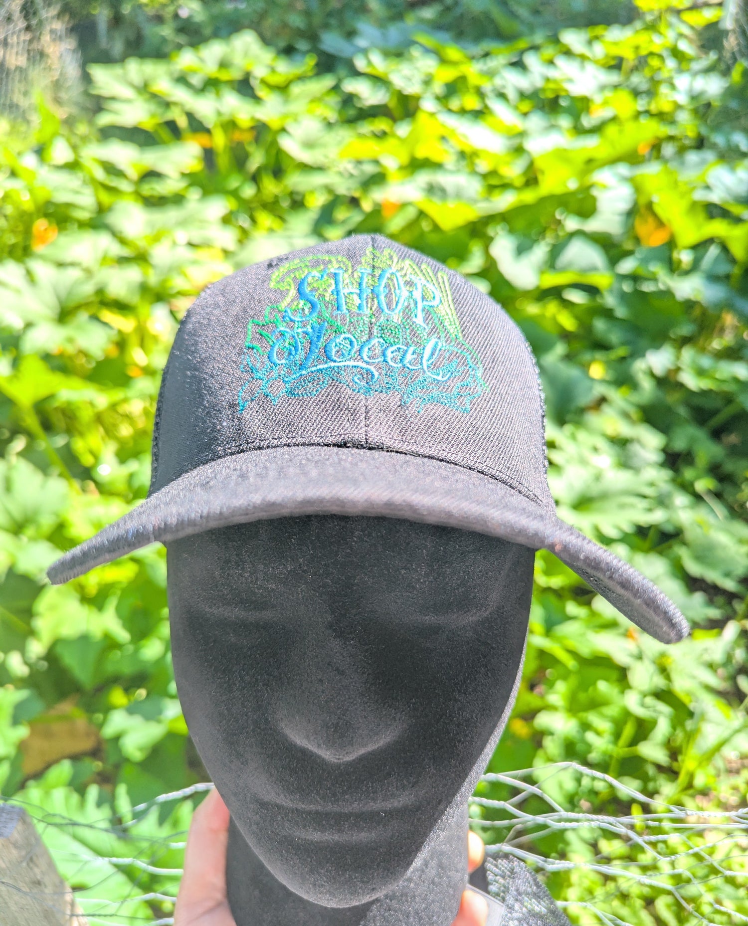 A black baseball cap with a colorful embroidered &