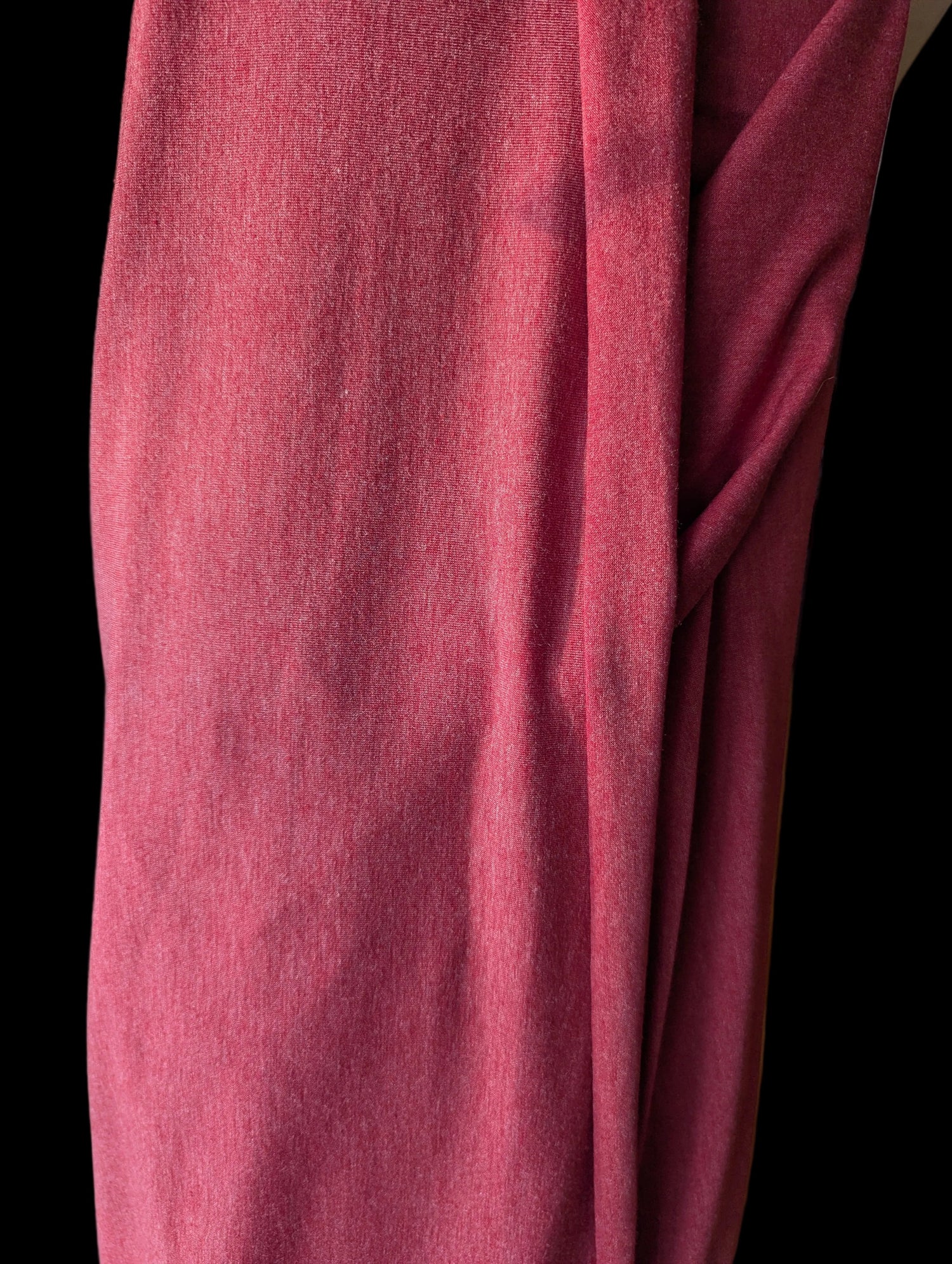 Vintage T-shirt weight cotton spandex in a red tomato color, draped off the bolt