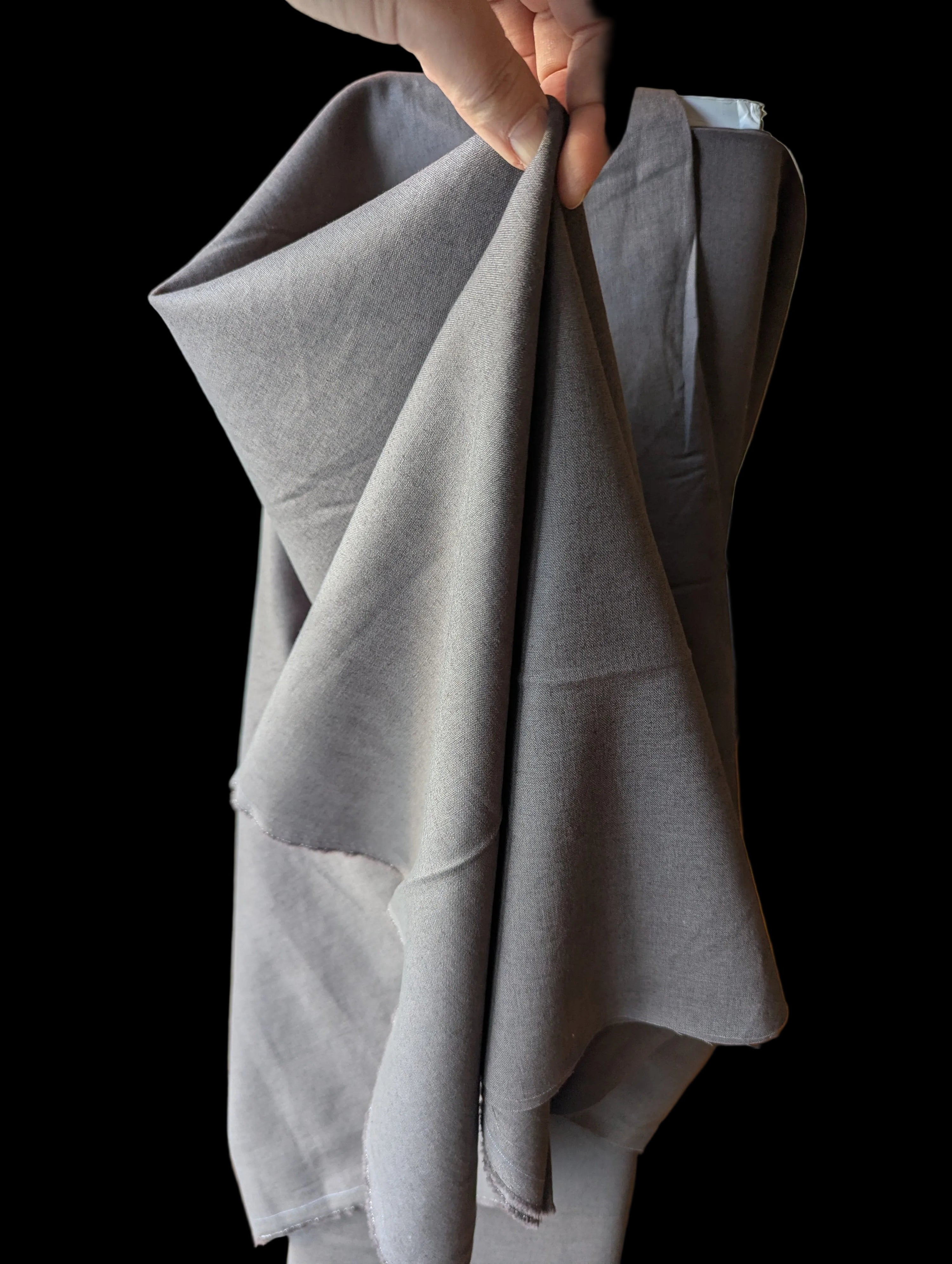 Gray Cotton linen blend held up to show structured drape.