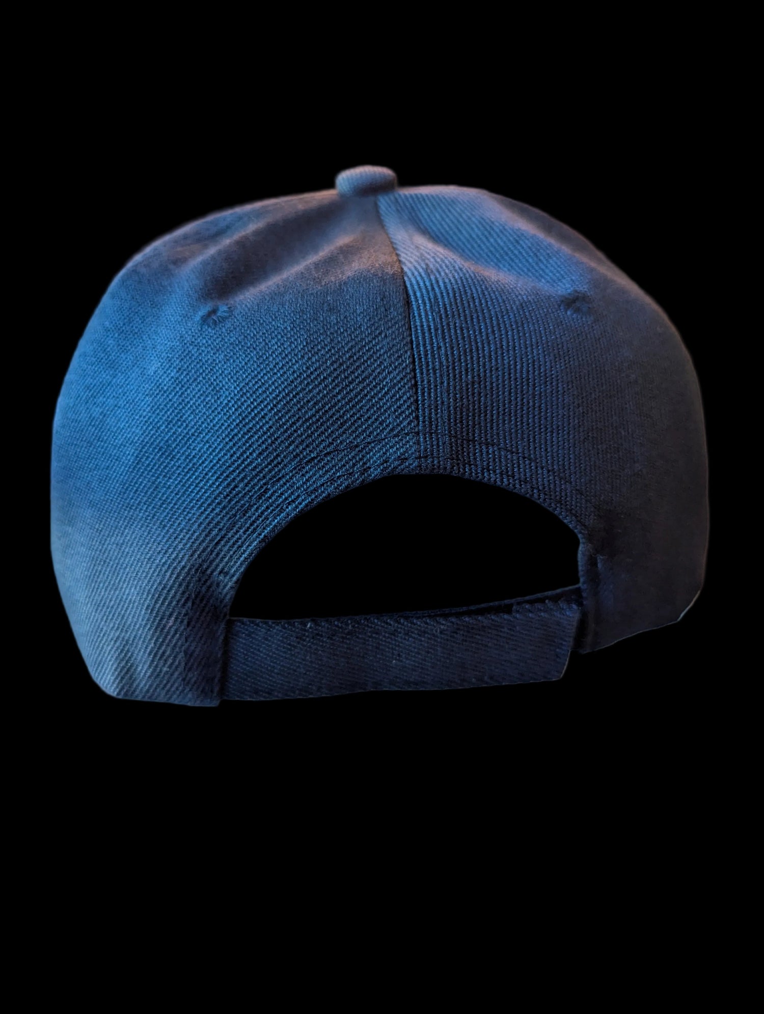 Back of a navy blue baseball cap with adjustable Velcro closure. 