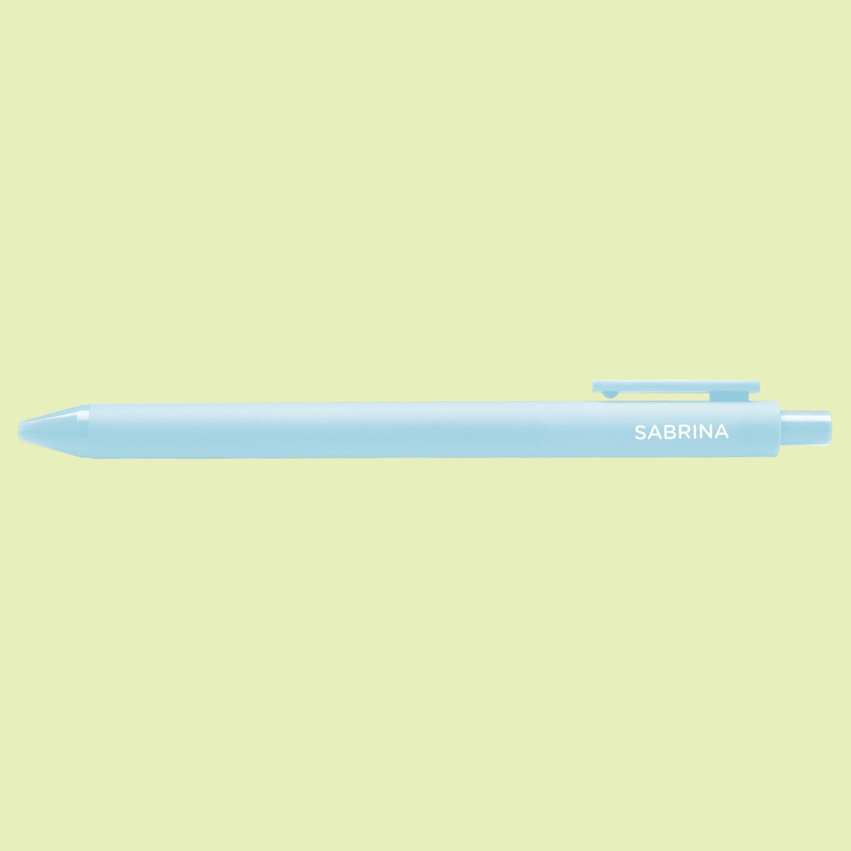 Sabrina pen flat lay — powder blue jotter gel pen on a light green background by indie artist MangoIllustrated