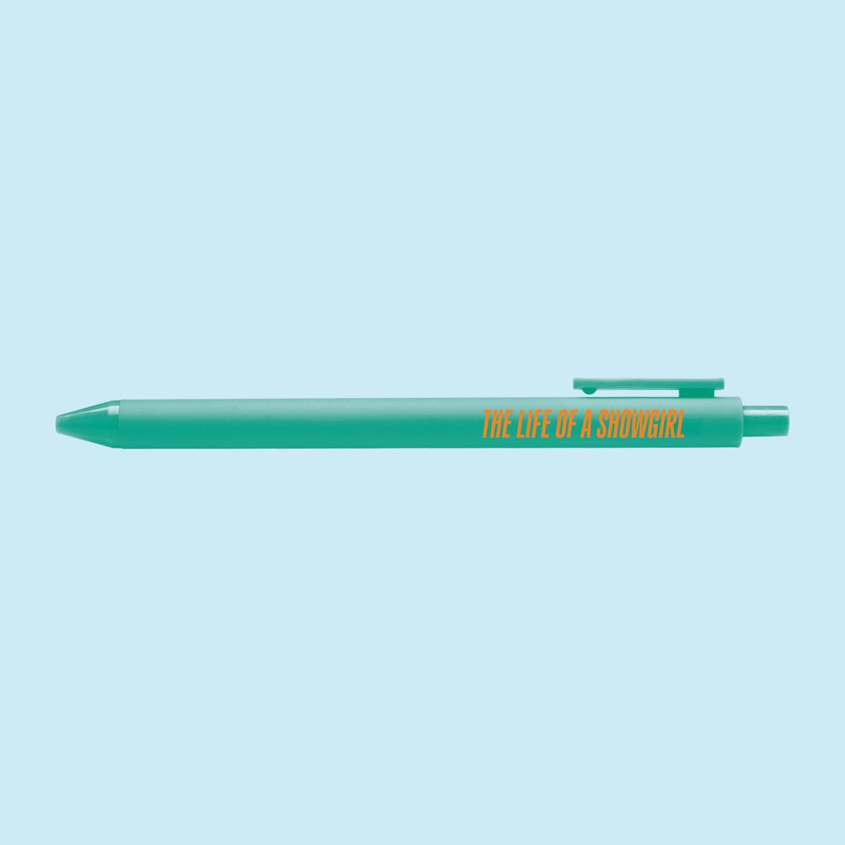 Showgirl pen flat lay — teal pop culture gel pen for desk and journaling by indie artist MangoIllustrated