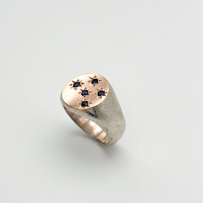 Sterling silver sand blasted ring with rose gold circular signet featuring 5 sapphire stones set in stars, made by hand in mexico, ethical artisan rings in chicago 