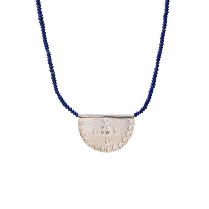 Ethically made in mexico, blue lapis lazuli beads with a Silver textured half-circle pendant, chicago jewelry store