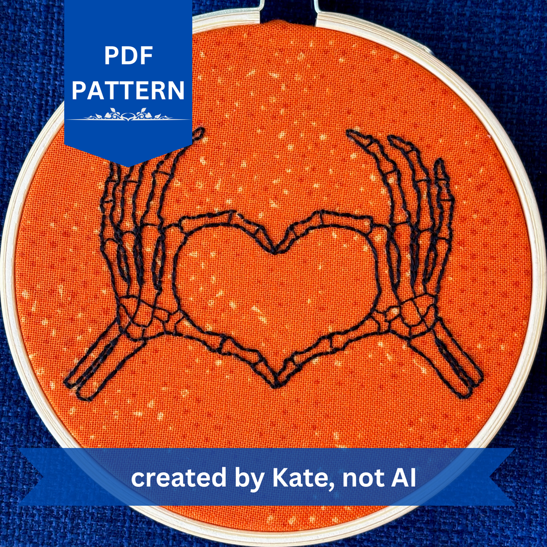 PDF pattern created by Kate, not AI. Hand embroidered pair of skeleton hands making a heart by touching thumbs and forefingers, while remaining fingers fan out. Bones are outlined with fine black embroidery. Stitched on bright orange cotton and displayed in light wooden hoop as wall art or Christmas ornament