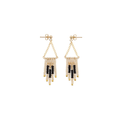 Pair of beaded earrings with gold, black, and white beads, handmade artisan earrings fair trade chicago 