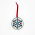 Embroidered by hand, blue red and silver snowflake design on a circular felt ornament strung with a red ribbon, ethically made by hand