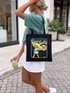 Person holding a tote bag with a graphic design outdoors reads stay salty melt ice