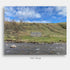 This striking landscape photograph captures a charming stone cottage on the banks of the River Tilt in Scotland, viewed from across the river beneath a brilliant blue Highland sky. The weathered cottage, though worn by time, retains a quiet beauty and character that reflects the rich history and enduring spirit of the Scottish countryside.