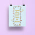 Story Tropes Charms art print — hand lettered quote a good story never loses its charm ringed by illustrated book trope charms on light blue, 8 x 10 in, by MangoIllustrated