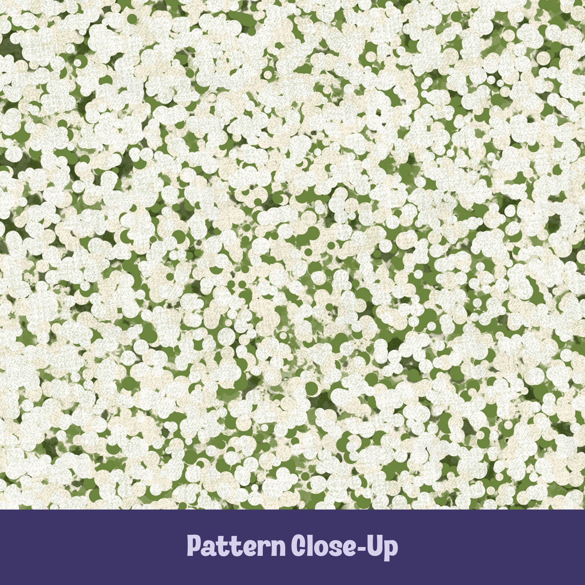 Close-up of sage green terrazzo pattern showing off-white pebble cluster shapes on olive green cotton twill ground