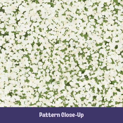 Close-up of sage green terrazzo pattern showing off-white pebble cluster shapes on olive green cotton twill ground