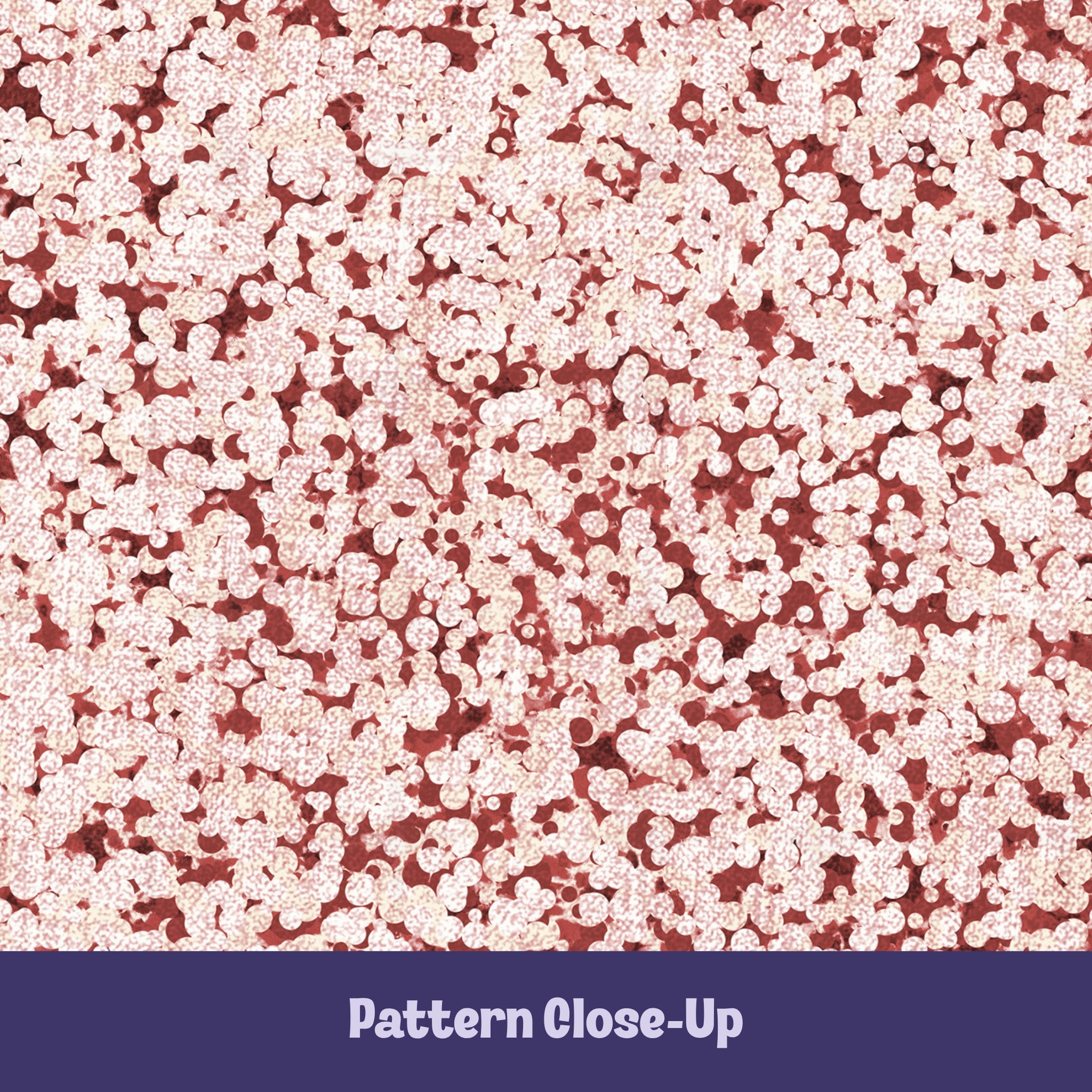 Close-up of terracotta red terrazzo pattern showing rounded cream pebble cluster shapes on brick red cotton twill ground