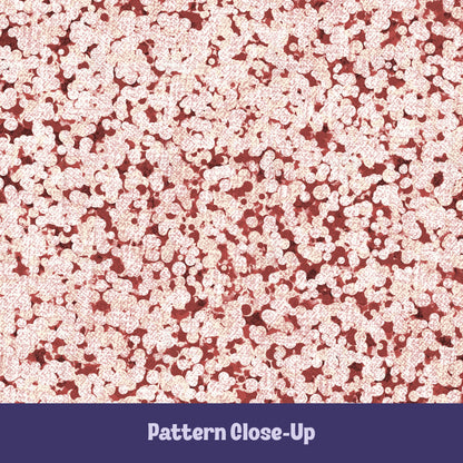 Close-up of terracotta red terrazzo pattern showing rounded cream pebble cluster shapes on brick red cotton twill ground
