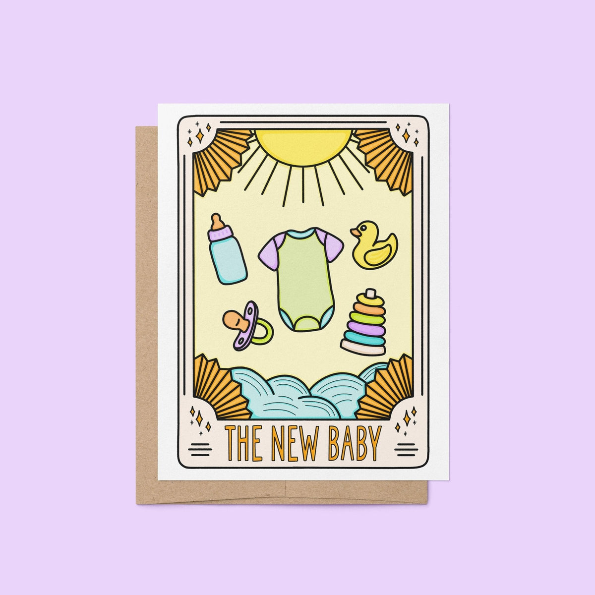 The New Baby Tarot Card Congratulations Card flat lay — gender neutral baby shower card styled on a desk by indie artist MangoIllustrated