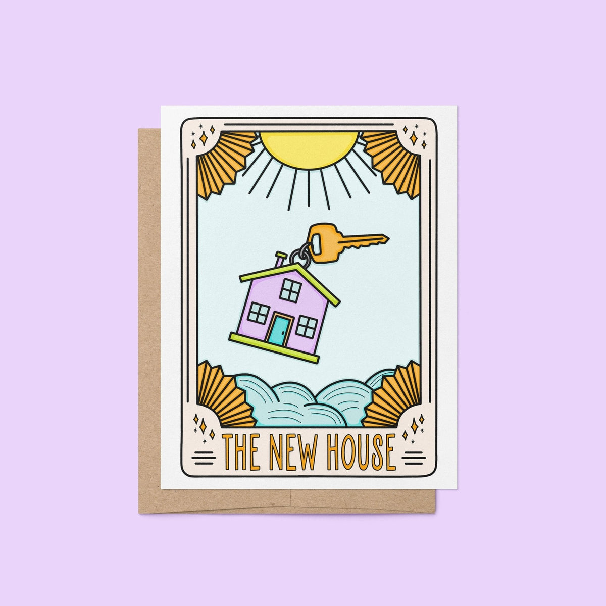 The New House Tarot Card Congratulations Card flat lay — pastel housewarming card styled on a desk by indie artist MangoIllustrated