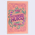 A flat lay image of a notebook with an orange cover featuring a purple-colored floral and text design, with the title &
