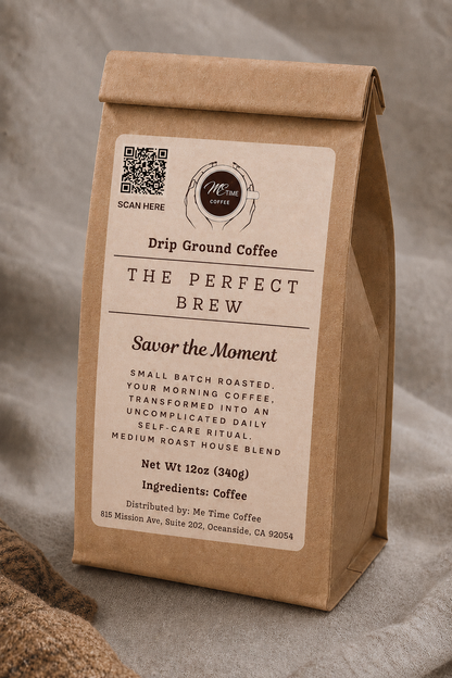 A brown kraft paper coffee bag standing upright on a soft gray fabric surface. The front label reads &