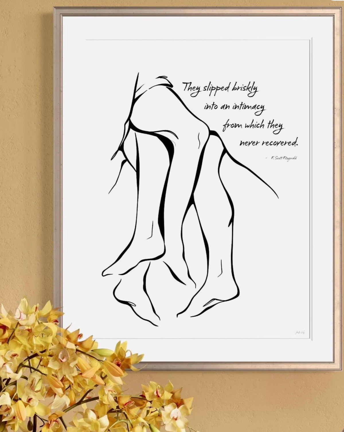Framed black and white art print featuring a minimalist line drawing of entwined legs. The artwork includes the quote, "They slipped briskly into an intimacy from which they never recovered." by F. Scott Fitzgerald.