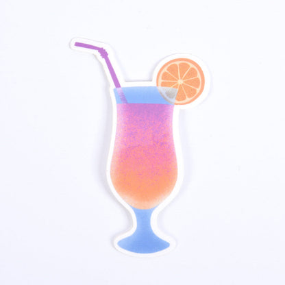 A sticker depicting a colorful cocktail with a swirl of orange liquid, accompanied by a straw and an orange slice