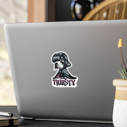 Small chibi vampire girl sticker with plum eyes and THIRSTY lettering on the back of a silver laptop