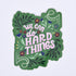 floral sticker with lettering "we can do hard things" on a green background