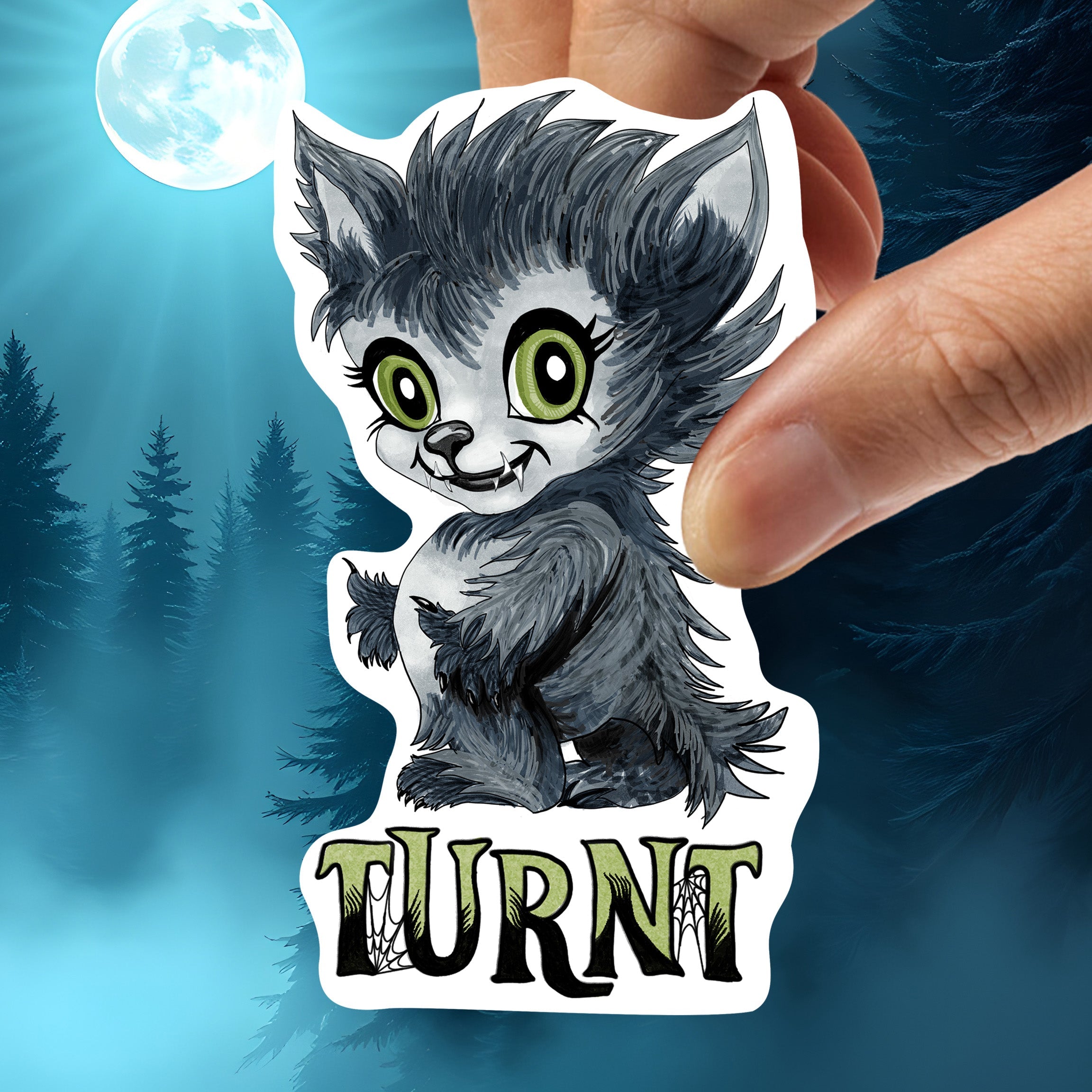Hand holding the creepy cute werewolf sticker to show scale and die-cut shape