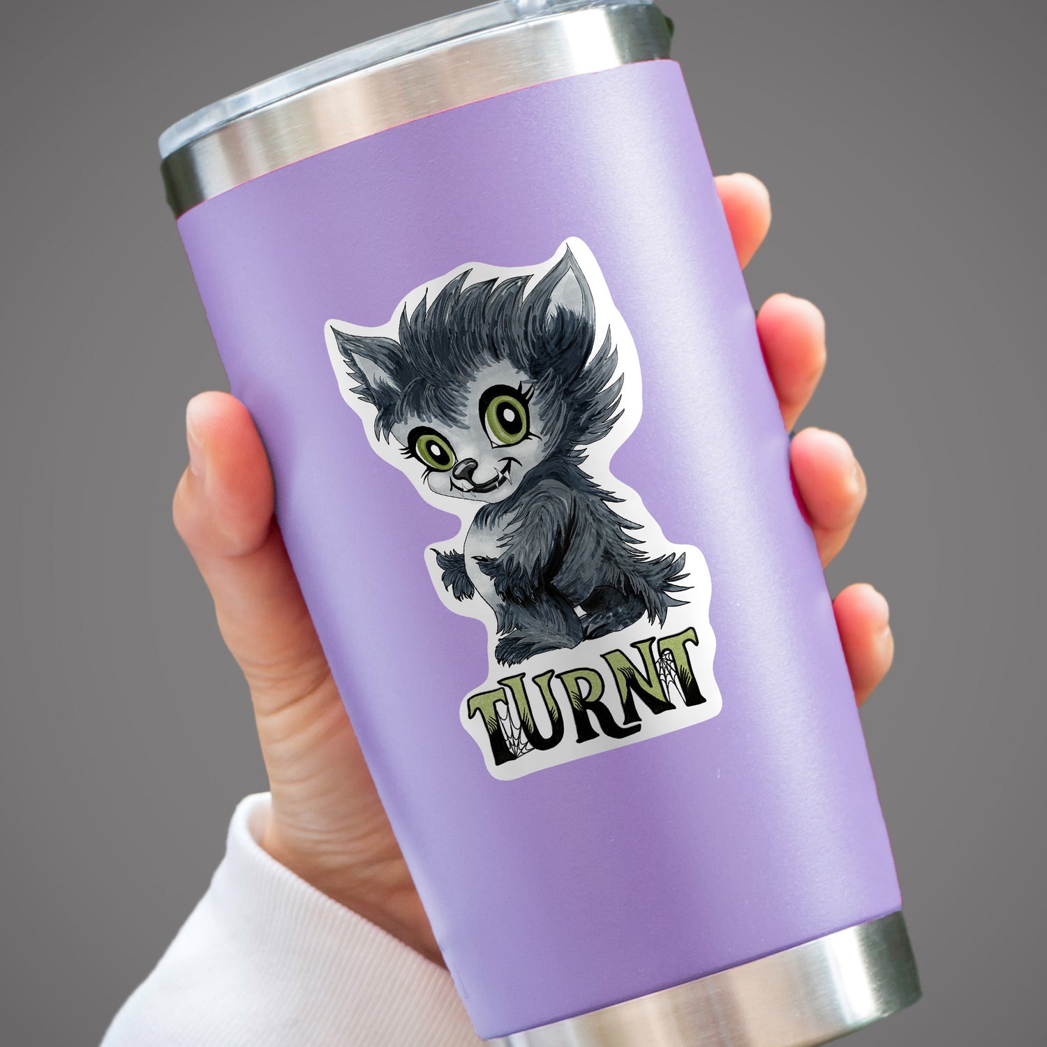 Turnt werewolf sticker on a lavender tumbler held in one hand