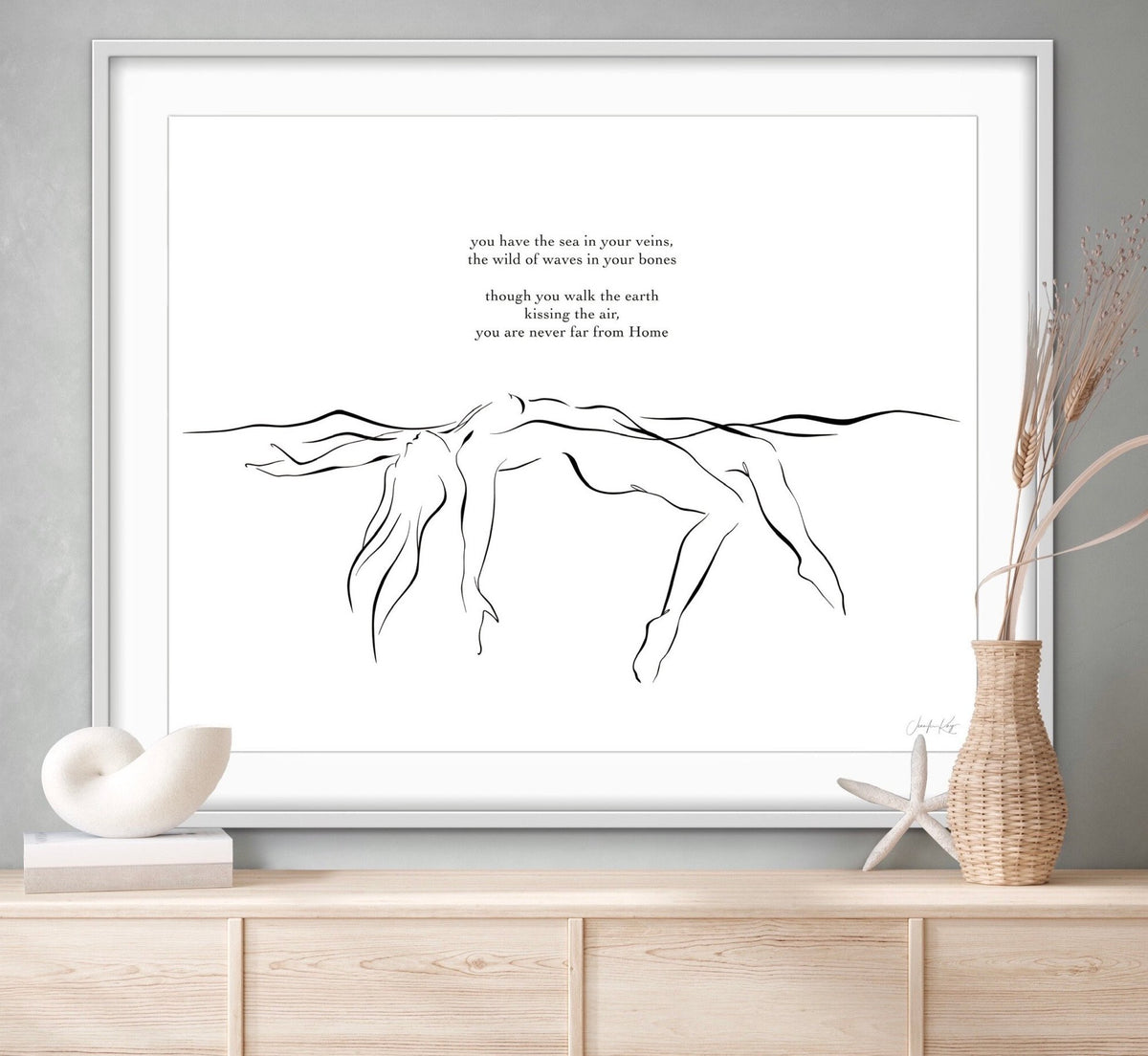 Black and white elegant line art illustration of sensual woman floating in water, in white frame among coastal decor.. Text reads: "you have the sea in your veins, the wild of waves in your bones, though you walk the earth kissing the air, you are never far from Home," written by the artist Jennifer Kay.