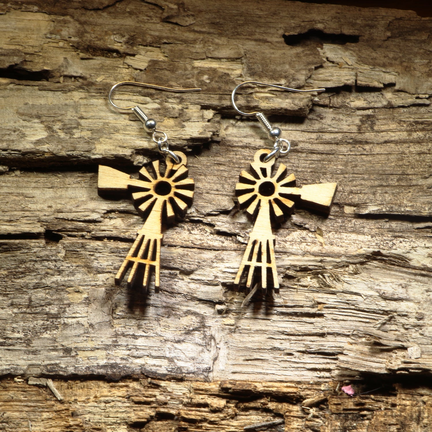 Hand-painted wooden windmill dangle earrings featuring a classic rustic windmill silhouette with detailed laser-cut blades. Crafted from lightweight wood with hypoallergenic .925 sterling silver hooks, these charming earrings are perfect for farmhouse décor lovers, country living enthusiasts, western style fans, rural Americana collectors, and anyone who appreciates unique rustic-inspired jewelry.