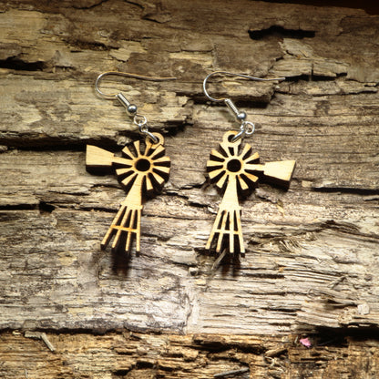 Hand-painted wooden windmill dangle earrings featuring a classic rustic windmill silhouette with detailed laser-cut blades. Crafted from lightweight wood with hypoallergenic .925 sterling silver hooks, these charming earrings are perfect for farmhouse décor lovers, country living enthusiasts, western style fans, rural Americana collectors, and anyone who appreciates unique rustic-inspired jewelry.