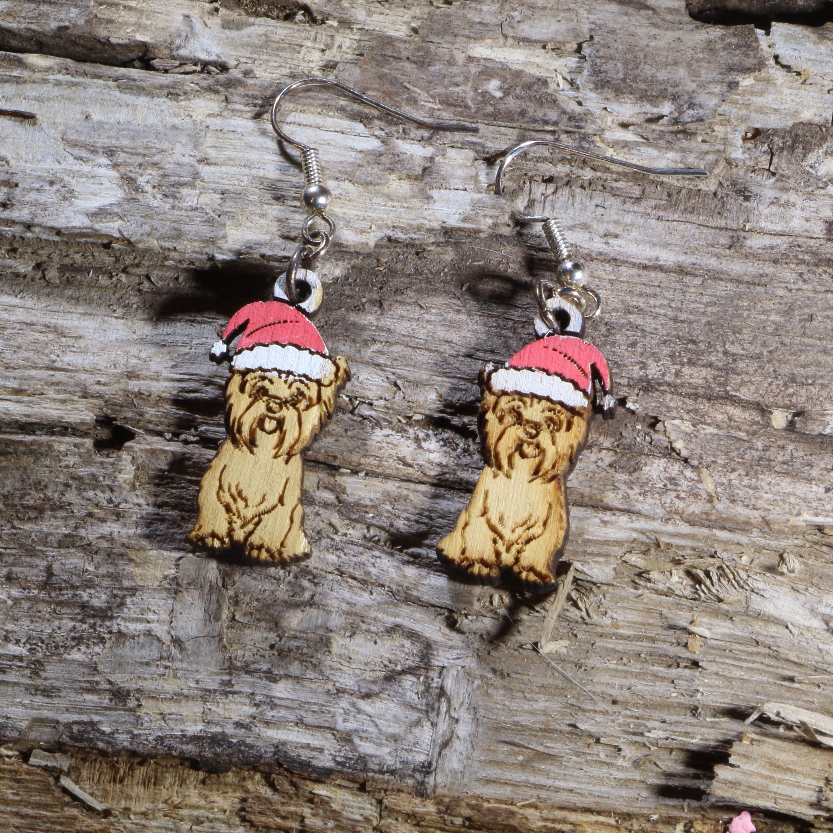 Hand-painted wooden Yorkie with Santa hat dangle earrings featuring an adorable Yorkshire Terrier wearing a festive red and white Santa hat. Lightweight Christmas dog earrings with hypoallergenic .925 sterling silver hooks, perfect for Yorkie lovers, dog moms, holiday parties, Christmas celebrations, and festive seasonal outfits.