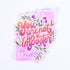 A sticker with a floral design and the lettering &