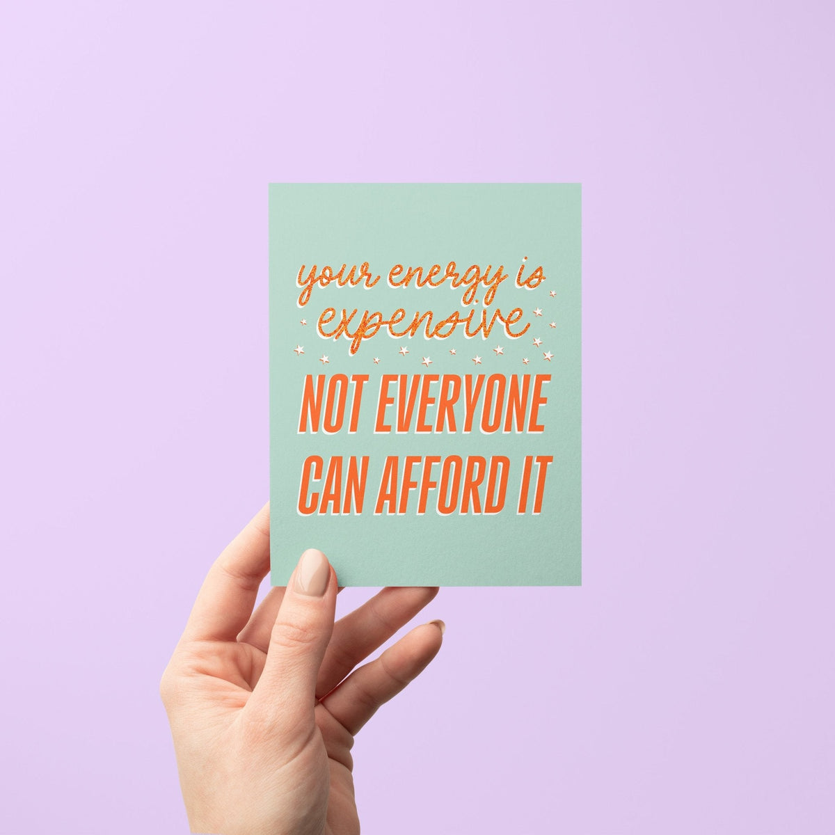 Your Energy is Expensive card in hand — encouragement card held to show its A2 size by indie artist MangoIllustrated