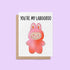 Greeting card with the phrase “You’re My Labooboo” above a cute pink monster illustration, blank inside with kraft envelope.